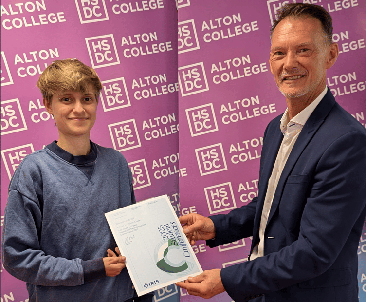 Oliver Withers-Clark receives a certificate from the Institute for Research in Schools Conference presented by Alton College's assistant principal for curriculum Ashley Grute, Alton College, August 14th 2025.