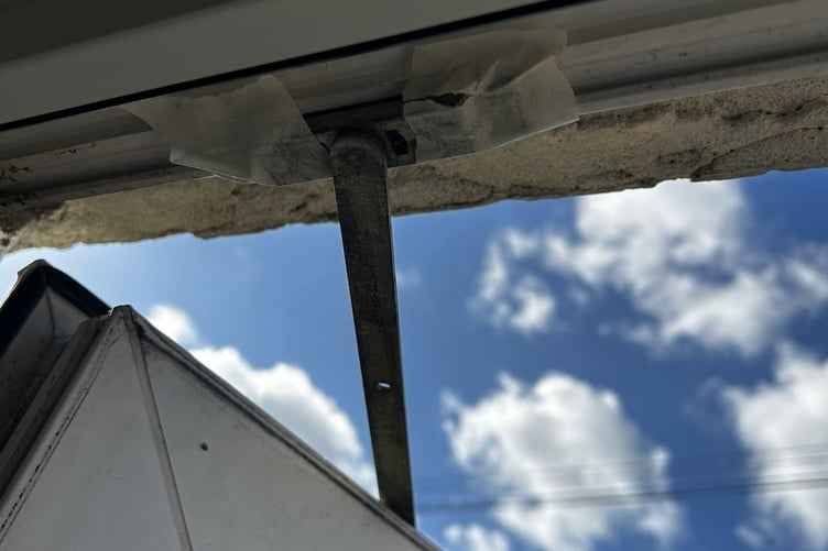 Window held together with tape at the Pines Estate in Bordon