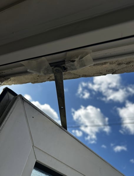 Window held together with tape at the Pines Estate in Bordon