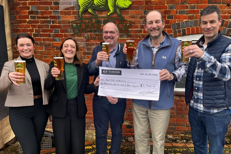 The Hogs Back Brewery team present a check to the Help for Heroes charity.