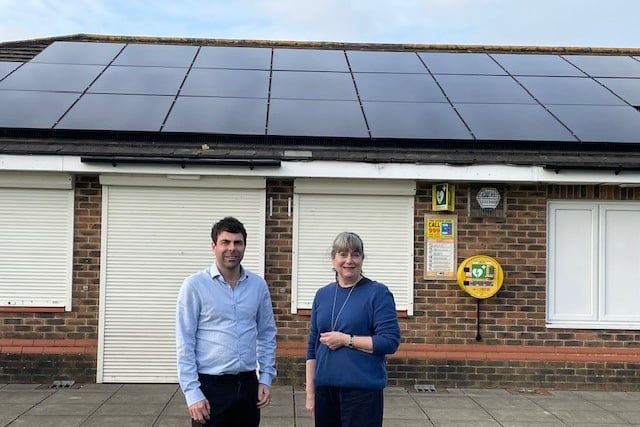 Whitehill Town Council leader Cllr Andy Tree and Deputy Town Mayor Cllr Linda Delve with the solar panels at the Mill Chase sport pavilion.