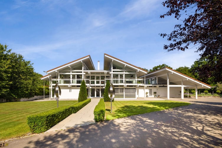 This luxury mansion with an entirely glass exterior is on sale for £4 million- with its own tennis courts and helicopter pad. A five-bedroom house within 20 acres of its own woodland on the Surrey and Sussex border has hit the market which has a striking glass exterior. The gardens of the property in Billingshurst, West Sussex, feature a three-acre lake with rainbow trout, a fishing pontoon, a workshop, a dehumidified multi?car garage, and a cottage. There is also an unrestricted helipad, and an air conditioned storage hanger to keep your helicopter in- which doubles as a golf simulator.