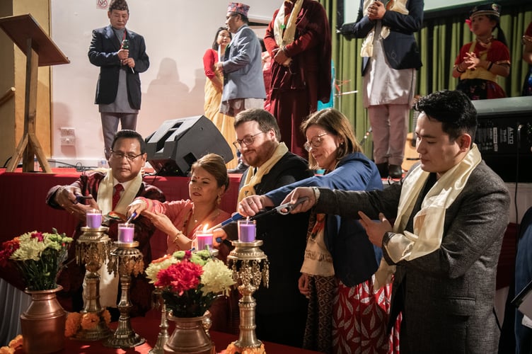 Labour MP Alex Baker and other guests light candles to mark the start of Nepali New Year.