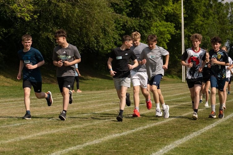 Young athletes complete a cool down lap at the end of the session