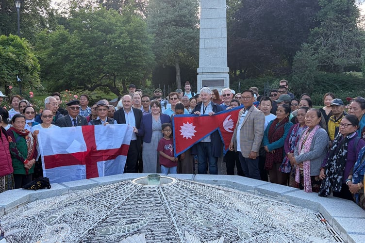 Dozens of members of the public gather to show their support to the Nepalese community