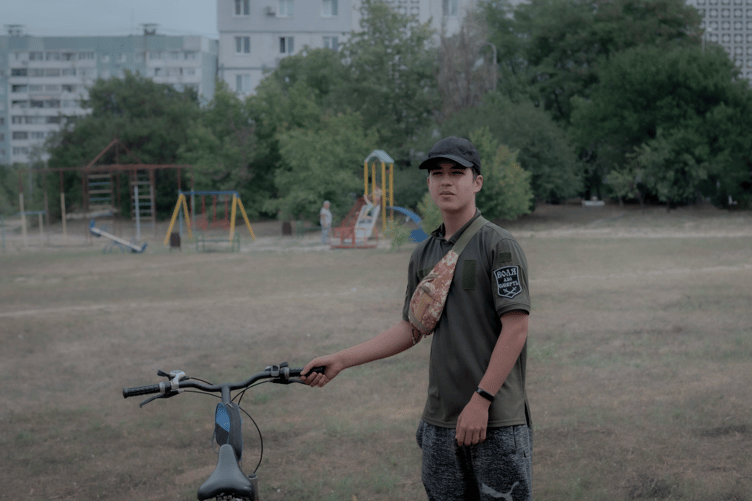 Vitalli, a Ukrainian teen wearing the shirt of his dead brother.