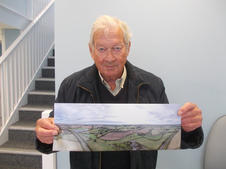 Martyn Spice shows a photograph of the whole area which could be covered by 630 acres of solar farms. An existing one can be seen by the A31 on the left. October 21st 2026.